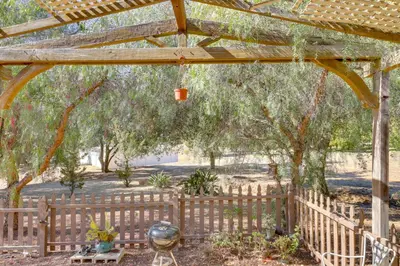a wooden pergola with a fence and trees at Hike, Explore and More Ranch Retreat in Escondido! in Valley Center