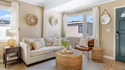 a living room with a couch and a table at The Edgewater Condos by AvantStay in Newport Beach