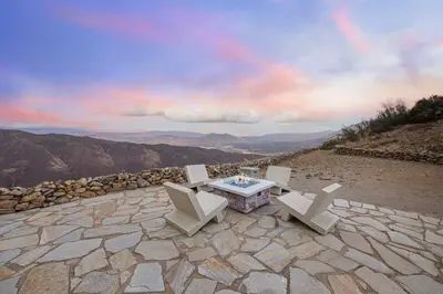 a patio with a table and chairs on top of a mountain at Unique Mountain Gem-Sauna Hot Tub Scenic View in Julian