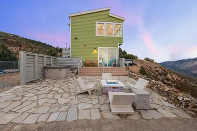 a green house on a hill with a patio at Unique Mountain Gem-Sauna Hot Tub Scenic View in Julian