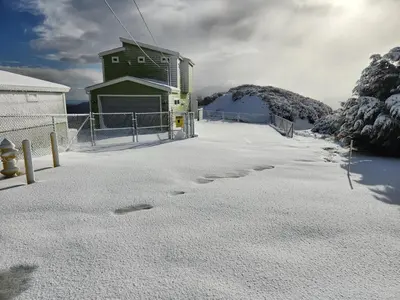 a snow covered parking lot with a building in the background at Unique Mountain Gem-Sauna Hot Tub Scenic View in Julian
