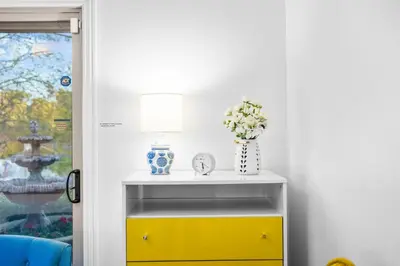 a yellow and white console table with a yellow drawer at Nature-Inspired Stay with Pool, Fire Pits and More in El Cajon