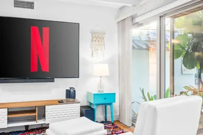 a living room with a tv on a wall at Nature-Inspired Stay with Pool, Fire Pits and More in El Cajon