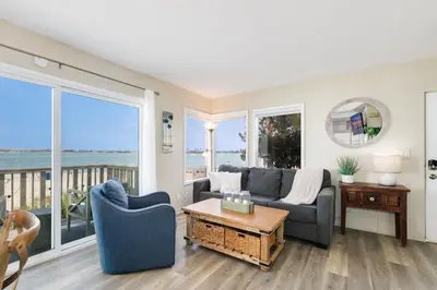 a living room with a couch and a table at Bayfront Oasis Close to Boardwalk and Water in San Diego