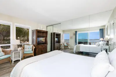 a bedroom with a bed and a living room at Bayfront Oasis Close to Boardwalk and Water in San Diego