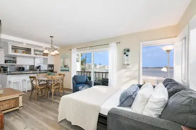a living room with a couch and a kitchen at Bayfront Oasis Close to Boardwalk and Water in San Diego