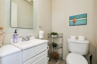 a white bathroom with a sink and a toilet at Bayfront Oasis Close to Boardwalk and Water in San Diego
