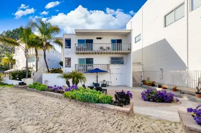 a house on the beach with purple flowers at Bayfront Oasis Close to Boardwalk and Water in San Diego
