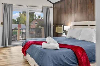 a bedroom with a bed with a towel on it at Mira Mesa Family Retreat 4BR with Balcony and Firepit in San Diego