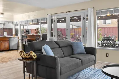 a living room with a couch and a kitchen at Mira Mesa Family Retreat 4BR with Balcony and Firepit in San Diego