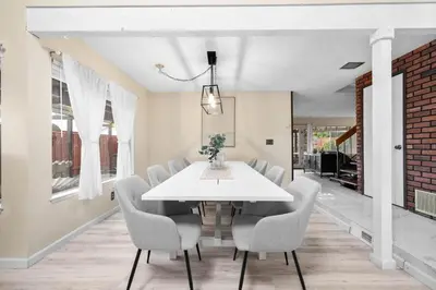 a dining room with a white table and chairs at Mira Mesa Family Retreat 4BR with Balcony and Firepit in San Diego