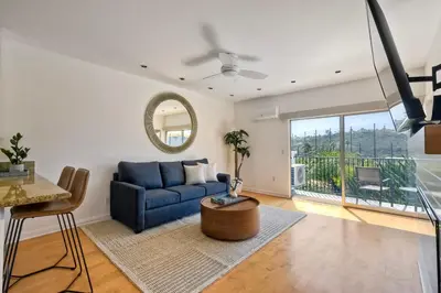 a living room with a blue couch and a table at Pool, Hot Tub, Steps To Omni La Costa in Carlsbad