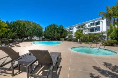 a patio with chairs and a swimming pool at Pool, Hot Tub, Steps To Omni La Costa in Carlsbad