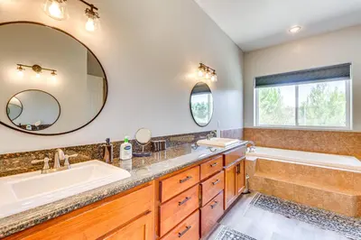 a bathroom with two sinks and a tub and a tubermott at Family Hideaway with Hillside Views in Temecula! in Temecula