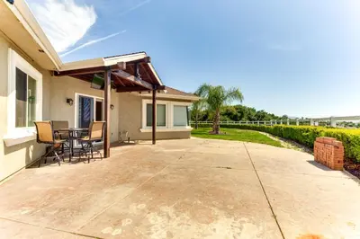 a patio with a table and chairs on a house at Family Hideaway with Hillside Views in Temecula! in Temecula