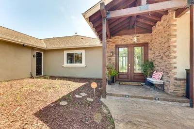 a house with a wooden door and a patio at Family Hideaway with Hillside Views in Temecula! in Temecula