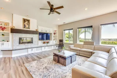 a living room with white furniture and a fireplace at Family Hideaway with Hillside Views in Temecula! in Temecula