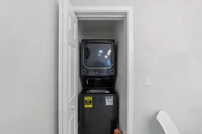 a small television sitting on top of a refrigerator at 2BR, 2B, Coffee Bar, Cozy Sectional, Rainfall Shower, Smart TVs, Cozy Beach Theme in San Diego