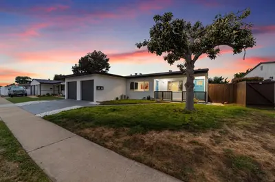 a house with a tree in the yard at 2BR, 2B, Coffee Bar, Cozy Sectional, Rainfall Shower, Smart TVs, Cozy Beach Theme in San Diego
