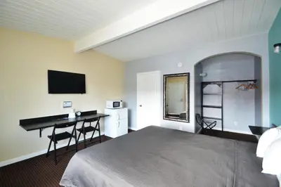 a bedroom with a bed and a desk and a computer at Lodge at 32nd in San Diego
