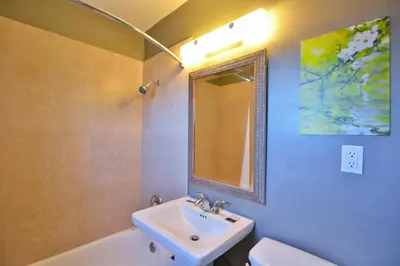 a bathroom with a sink and a toilet and a mirror at Lodge at 32nd in San Diego
