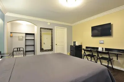 a bedroom with a bed and a table with chairs at Lodge at 32nd in San Diego