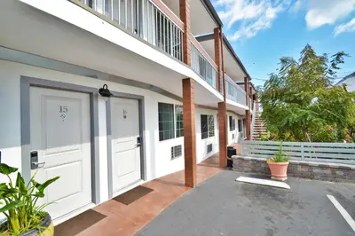 a house with white doors and a balcony at Lodge at 32nd in San Diego