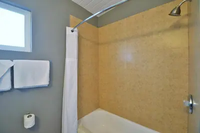 a bathroom with a shower and a bath tub at Lodge at 32nd in San Diego