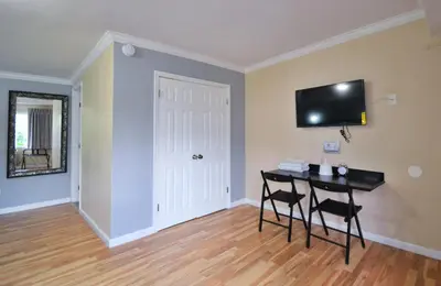 a room with a table and two chairs and a television on the wall at Lodge at 32nd in San Diego