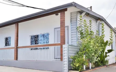 a small white house with a window at Lodge at 32nd in San Diego