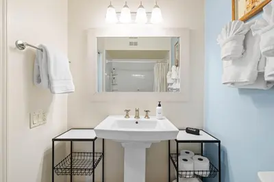 a white bathroom with a sink and a mirror at Charming Coastal Retreat in Solana Beach in Solana Beach