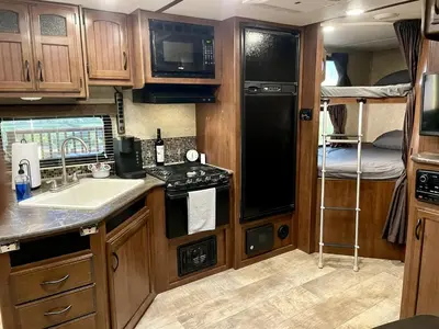an rv kitchen with a sink and a microwave at Cozy Camper with Fire Pit and Beautiful Sunsets in California in Temecula