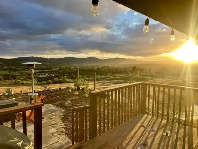 a view of the mountains from the deck of a house at Cozy Camper with Fire Pit and Beautiful Sunsets in California in Temecula