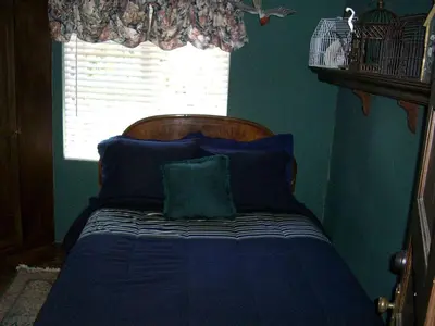 a blue bedroom with a bed with a window at Grand Rustic Cabin Rental with Private Hot Tub near Escondido, California in Julian
