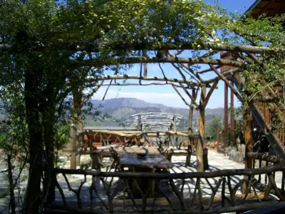 a view of a patio with a table and chairs at Grand Rustic Cabin Rental with Private Hot Tub near Escondido, California in Julian