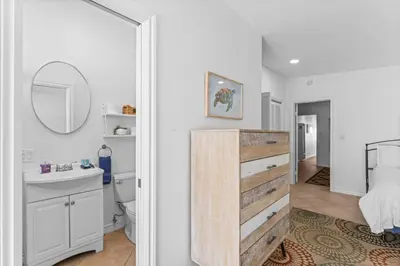 a bathroom with a sink and a toilet and a mirror at Private beach toes on the Sand Waterworld in Dana Point