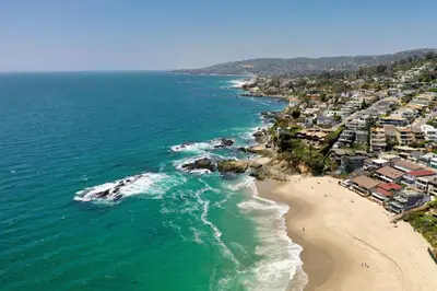 an aerial view of a beach and the ocean at Penthouse Steps from Victoria Beach 180 degree ocean views in Laguna Beach