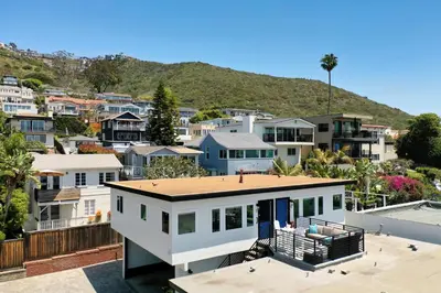 a large white house in a city with houses at Penthouse Steps from Victoria Beach 180 degree ocean views in Laguna Beach