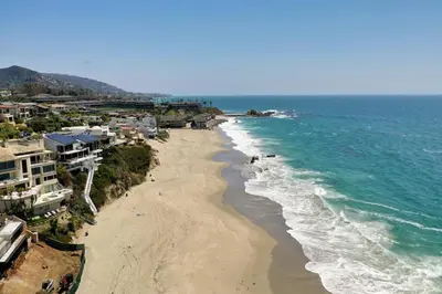 an aerial view of a beach with houses and the ocean at Penthouse Steps from Victoria Beach 180 degree ocean views in Laguna Beach