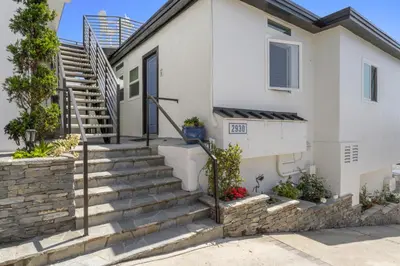 a white house with stairs in front of it at Ocean VIEWS Steps from Victoria Beach Lux Design in Laguna Beach