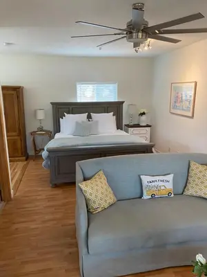 a living room with a bed and a couch at Rustic Ridge Vineyards Cottage in Jamul