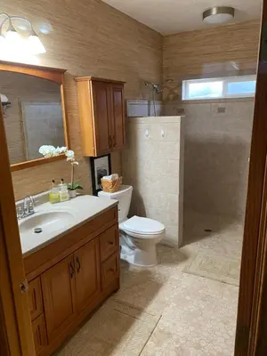 a bathroom with a toilet and a sink and a shower at Rustic Ridge Vineyards Cottage in Jamul