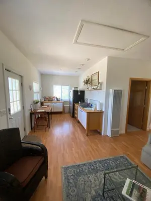 a living room with a couch and a table at Rustic Ridge Vineyards Cottage in Jamul