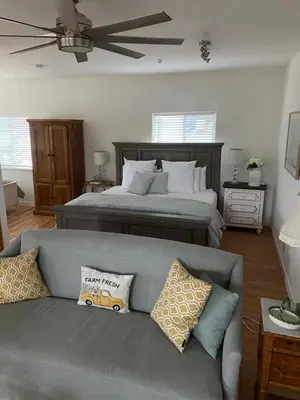 a living room with a couch and a bed at Rustic Ridge Vineyards Cottage in Jamul