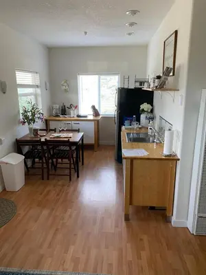 a kitchen and dining room with a table and a sink at Rustic Ridge Vineyards Cottage in Jamul