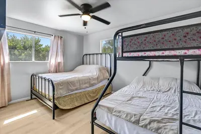 two bunk beds in a room with a ceiling fan at 16 Plus ADU Solana Beach DelMar Fair in Encinitas
