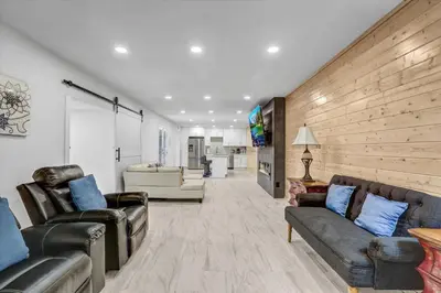 a living room with leather furniture and a wooden wall at 16 Plus ADU Solana Beach DelMar Fair in Encinitas