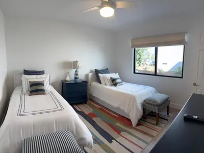 a bedroom with two beds and a window at Modern Laguna Beach Duplex - Prime Location! in Laguna Beach