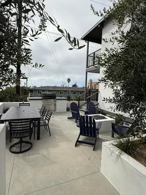 a patio with a table and chairs and a building at Modern Laguna Beach Duplex - Prime Location! in Laguna Beach
