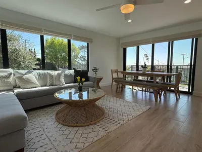 a living room with a couch and a table at Modern Laguna Beach Duplex - Prime Location! in Laguna Beach